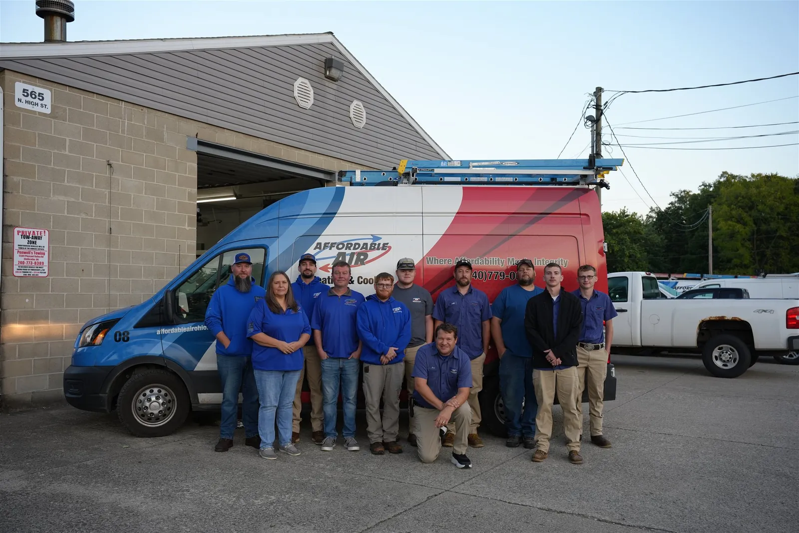 Affordable Air Heating & Cooling team gathered in front of their branded service van.